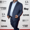 Actor Luis Guzman in front of a step and repeat for the Latinos de Hoy Awards