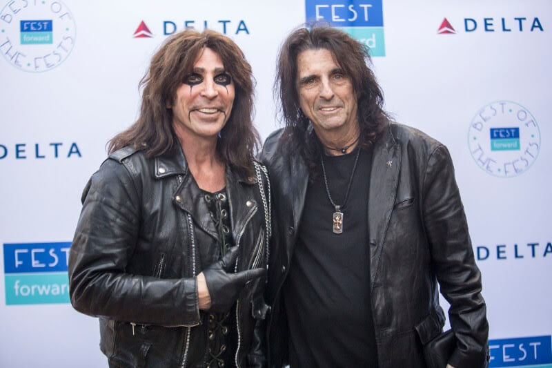 Alice Cooper posing in front of a step and repeat at Fest Forward.