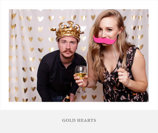 A simple photo backdrop with gold hearts