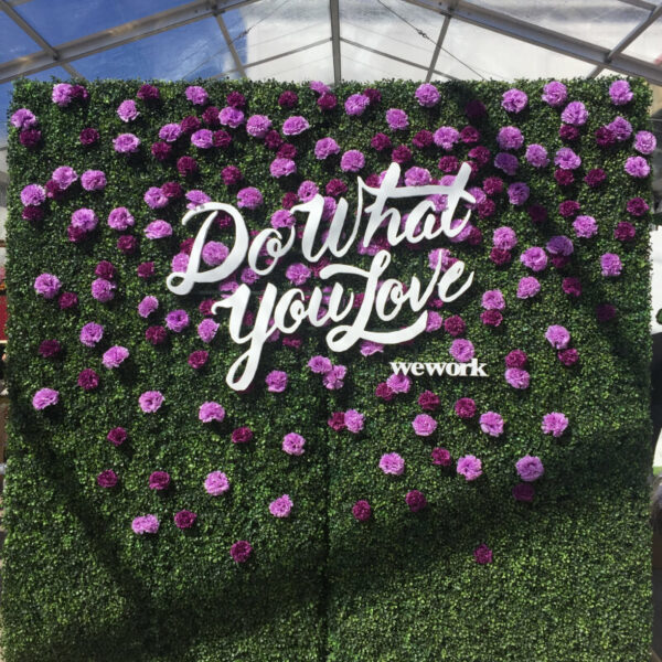 A Hedge Wall with custom cutout lettering and flowers