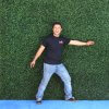 Man in front of a Hedge Roll backdrop